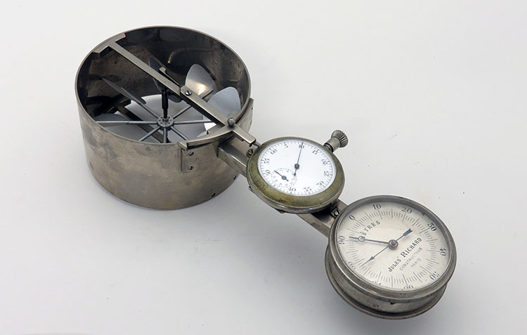 A three-part device with blades in a cut cylinder at one end, a stopwatch in the middle, and and third dial at the end.