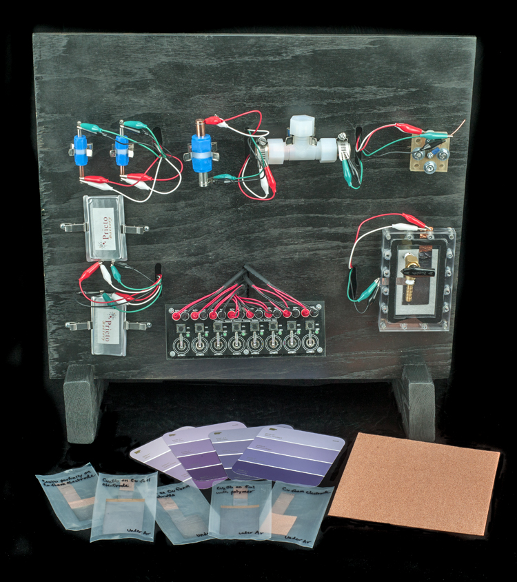 Components of prototype Prieto batteries, 2014. A wooden board holds several different types of cells for testing