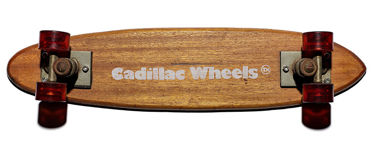 Bottom view of wooden skateboard with the words “Cadillac Wheels” on the bottom
