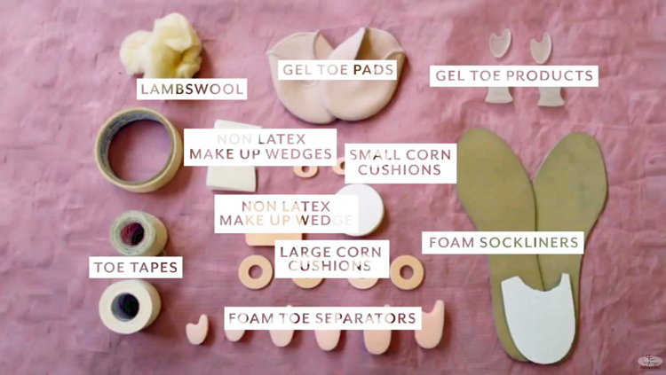 Assorted pointe shoe padding materials, including lamb’s wool, foam wedges, and corn cushions.