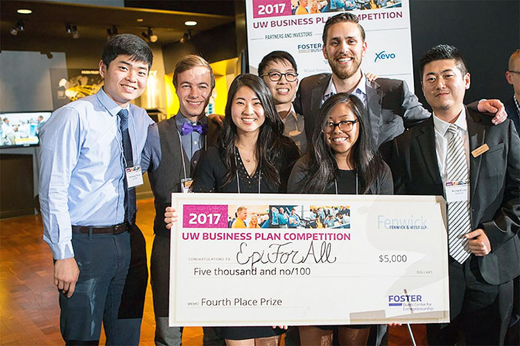 A group of 7 people posing with an oversized check