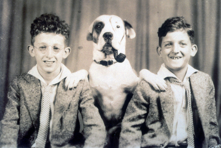 Jerome Lemelson as a child, posing with his brother Howard. The family dog is between the boys. The dog sits with his front paws on either boy’s shoulder and has a pipe in its mouth. Its face has been painted to look like Petey, the dog in the Little Rascals Our Gang comedies.