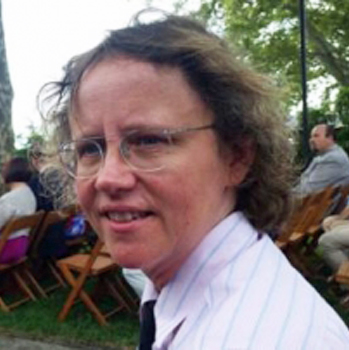 Candid headshot of 2017 Lemelson Fellow Heidi Voskuhl. She is sitting in an audience of people outdoors and has turned her head towards the camera.