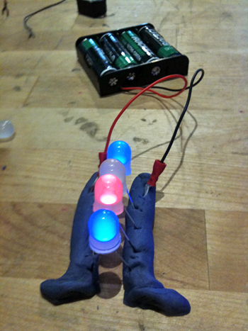 Squishy circuits made of clay conduct electricity to LED lamps