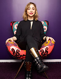 Ayah Bdeir, sitting in a multicolored chair
