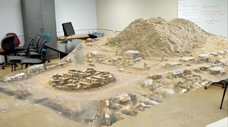 A three-dimensional map of a mountainside and village in a desert climate designed to be viewed and manipulated by someone wearing the hololens system to better understand the environment.