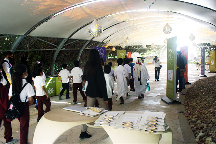 A group of students and their teachers walk into the temporary Spark!Lab space in Doha, Qatar.