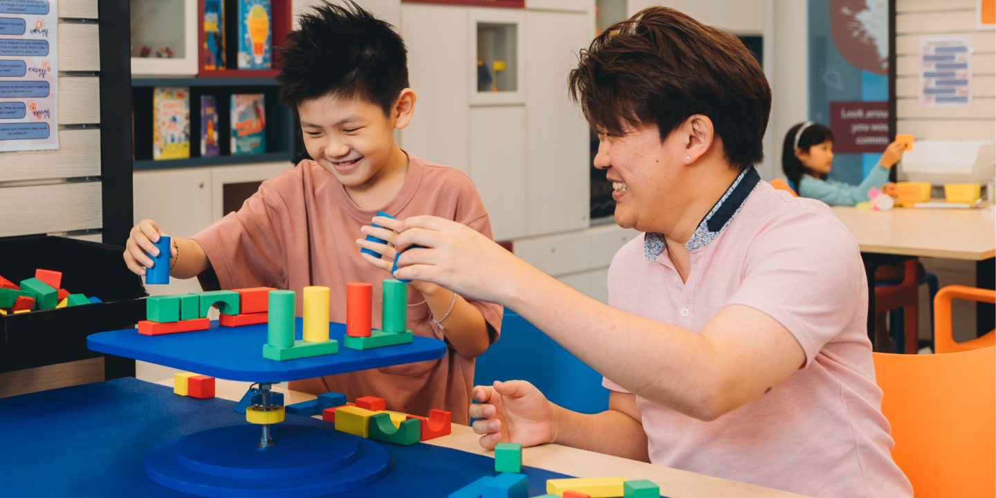 Two people working with blocks