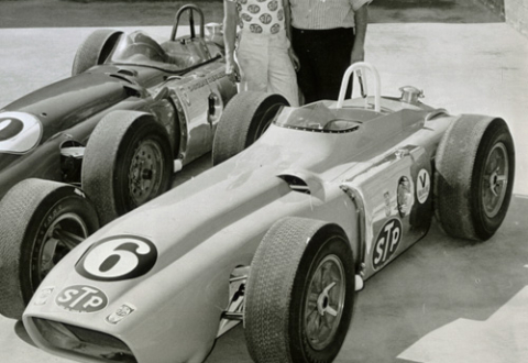 Andy Granatelli and his brother Vincent standing behind two race cars