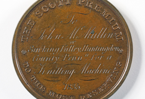 The reverse side of the John Scott medal, inscribed, “THE SCOTT PREMIUM TO THE MOST DESERVING To John McMullin [sic] of Sinking Valley, Huntingdon County Penna. for a Knitting Machine 1835.”