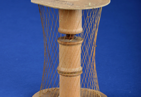 Hyperboloid model made of cardboard, wood, thread, wire, and thread spools