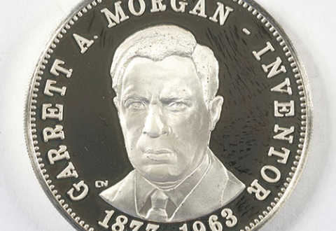 A round medal that looks like a coin, embossed with Morgan’s portrait and the words Garrett A. Morgan, Inventor, 1877–1963