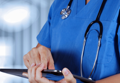 Female health professional with tablet computer, stock photo via Shutterstock