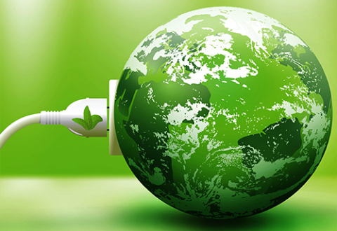 A planet earth globe with a green-hue is being plugged into a USB outlet.