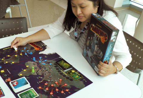 A young woman playing Pandemic