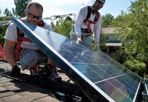 Workers installing solar panels on a home in Englewood, Colorado, in 2012