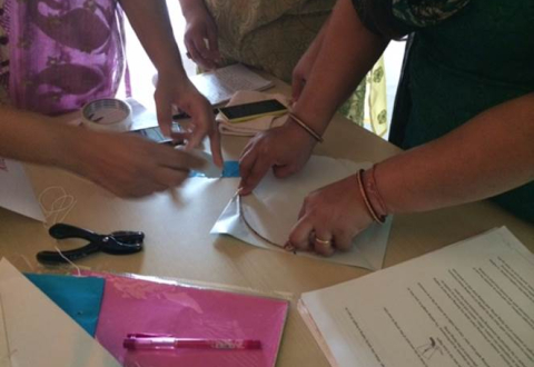 Spark!Lab India staff fold paper to make traditional kites.