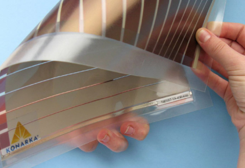 Person's hands bending a flexible thin film solar panel