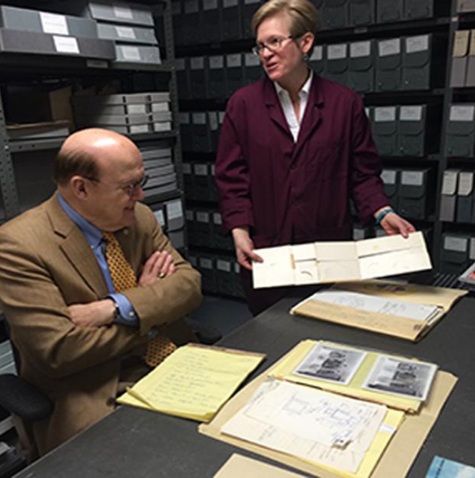 Alison Oswald assisting a person in the museum's archives