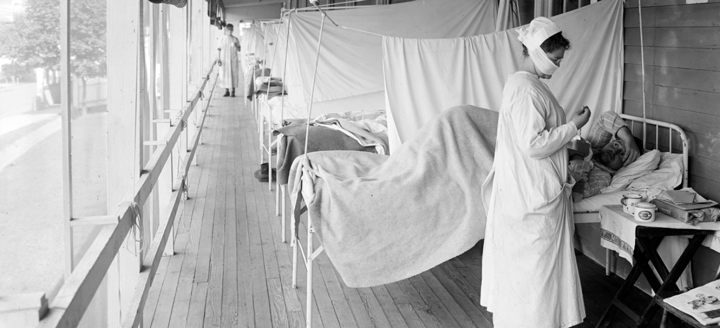 A nurse tending to a bedridden patient