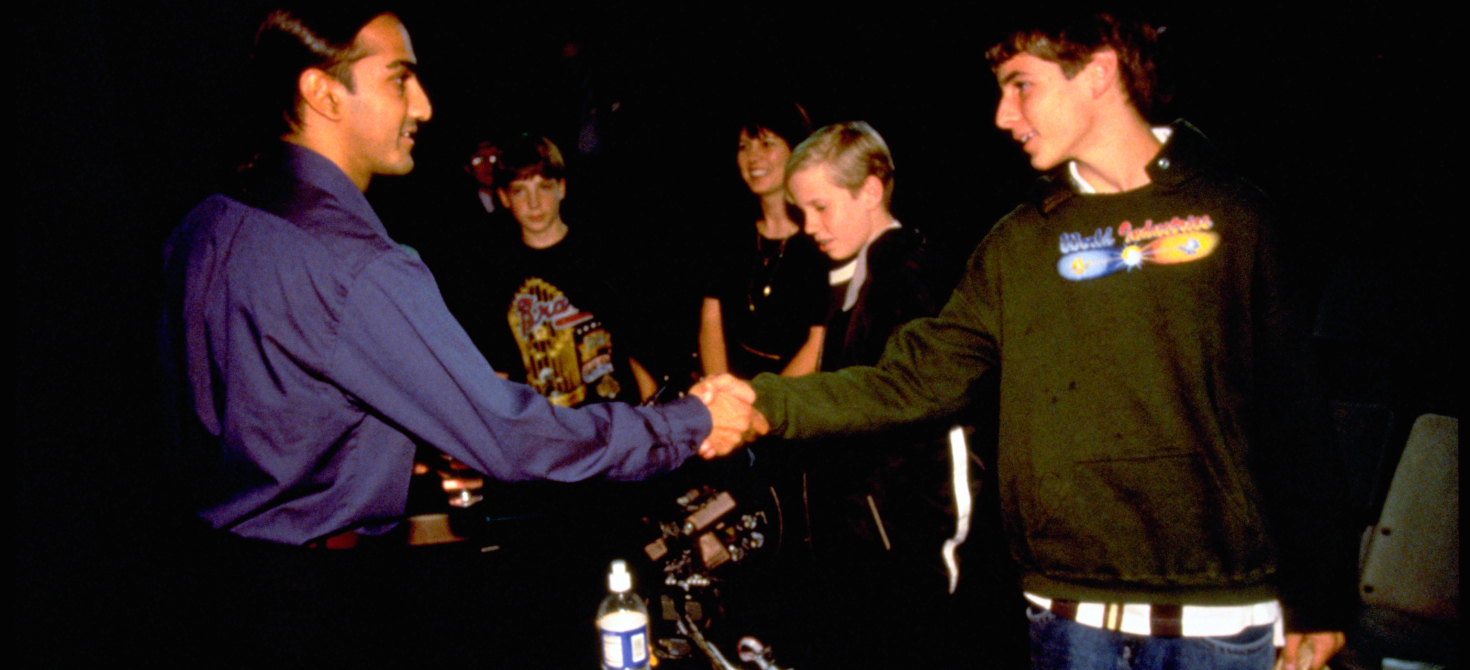 Inventor Akhil Madhani interacts with students during an Innovative Lives presentation