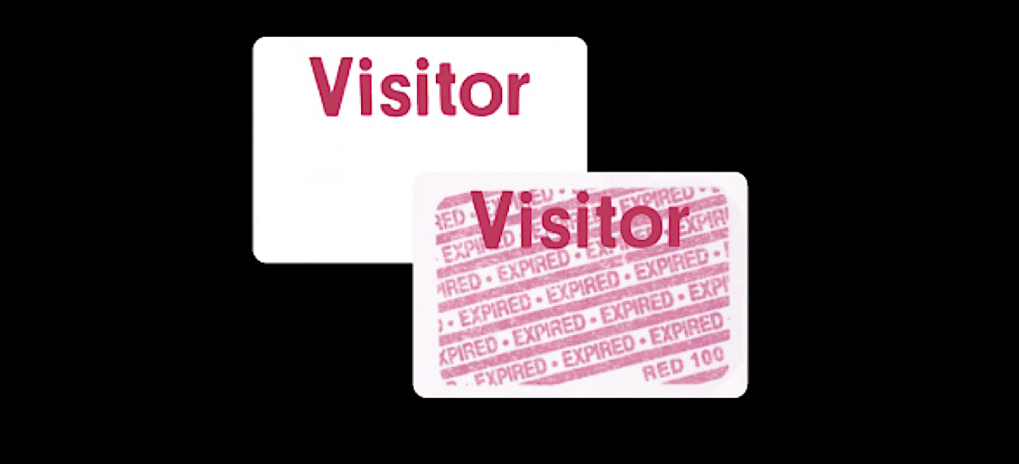 Two badges marked “Visitor,” one with white background and one with “Expired” in red bars across the badge