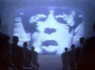 Scene from Apple’s “1984” Super Bowl advertisement: large, projected talking head.