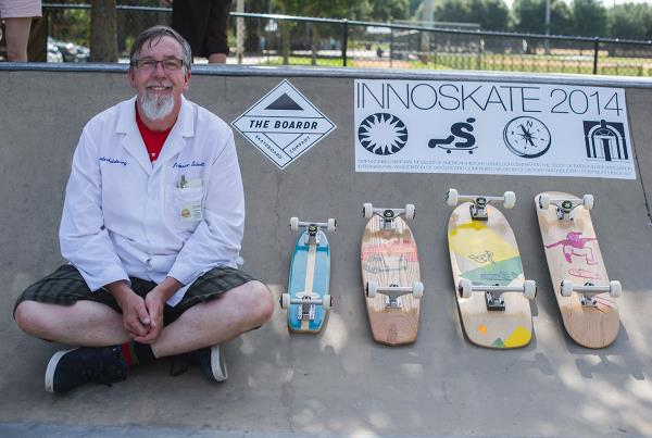 Professor Paul Schmitt with his replica boards representing different eras.