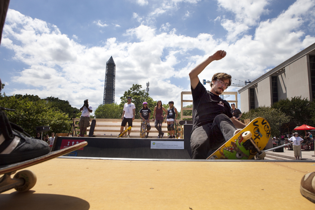 Shaun Gregoire rides the mini ramp in front of the Washington Monument and the National Museum of American History.