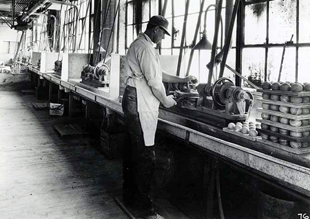 Man using polishing lathe during Celluloid billiard ball manufacture