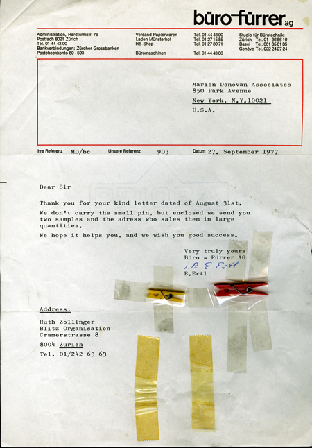 A typewritten letter, dated 27 September 1977, from Büro-Fürrer AG in Switzerland to Marion O’Brien Donovan, in response to Donovan’s inquiry about a source for small clothespins to use with her closet organizer. Two clothespins are taped to the letter; one is yellow and about 1 inch long, the other is red and about 1.5 inches long.