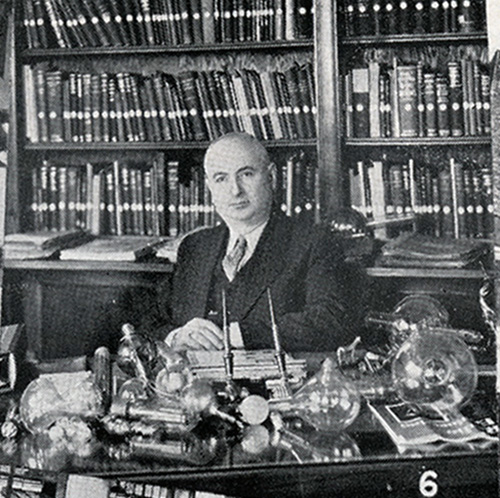 Charles (Károlyi) Eisler sitting at his desk