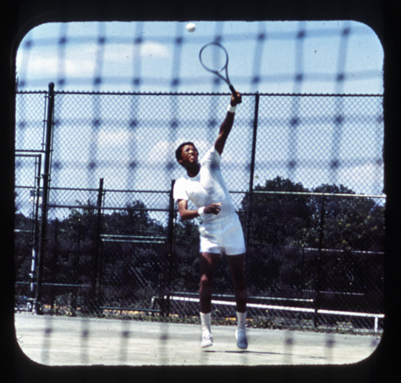 Arthur Ashe in mid-swing