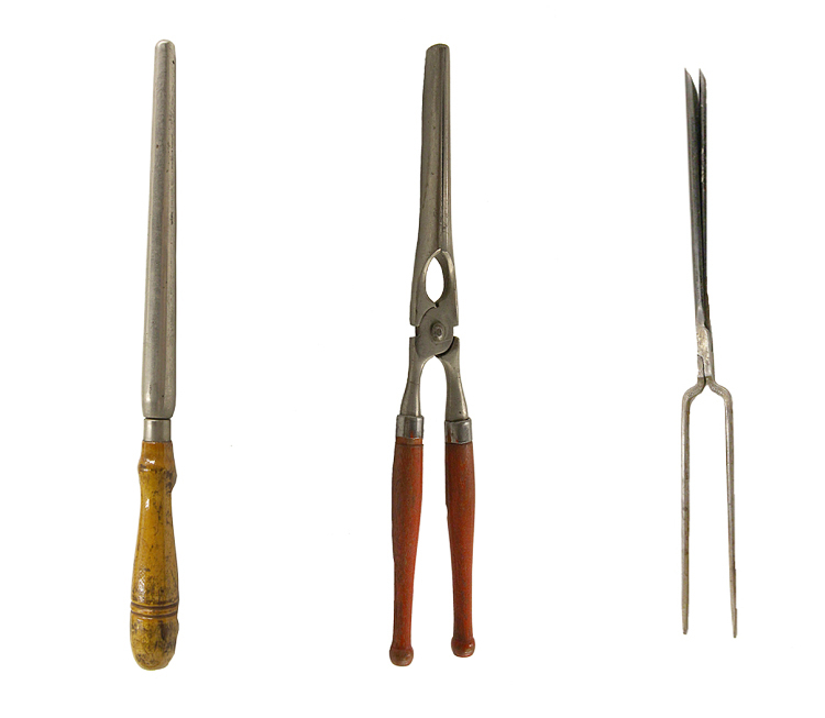 3 hairstyling instruments in a row. A metal permanent rod with a wooden handle is at the left. A metal straightening iron with two hinged tongs and wooden handles is in the center. An all-metal curling iron with 2 narrow tine-like handles and 2 tweezer-shaped tongs is at the right.