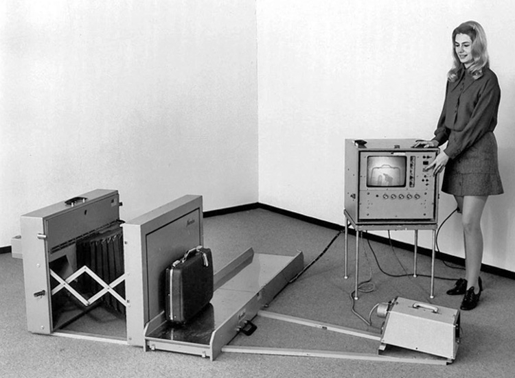 Woman standing by X-ray system demonstration unit