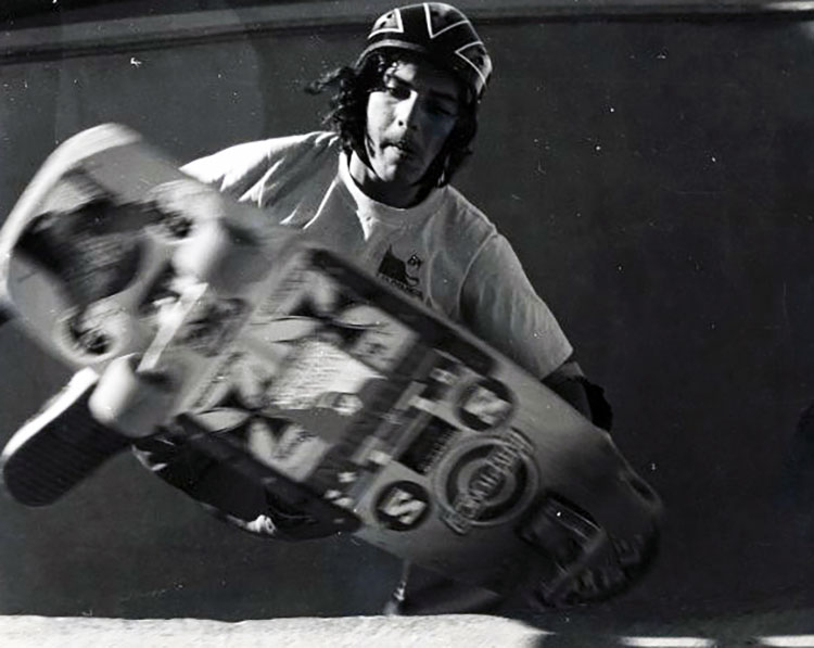 Skateboarder airborne doing a trick, facing the camera