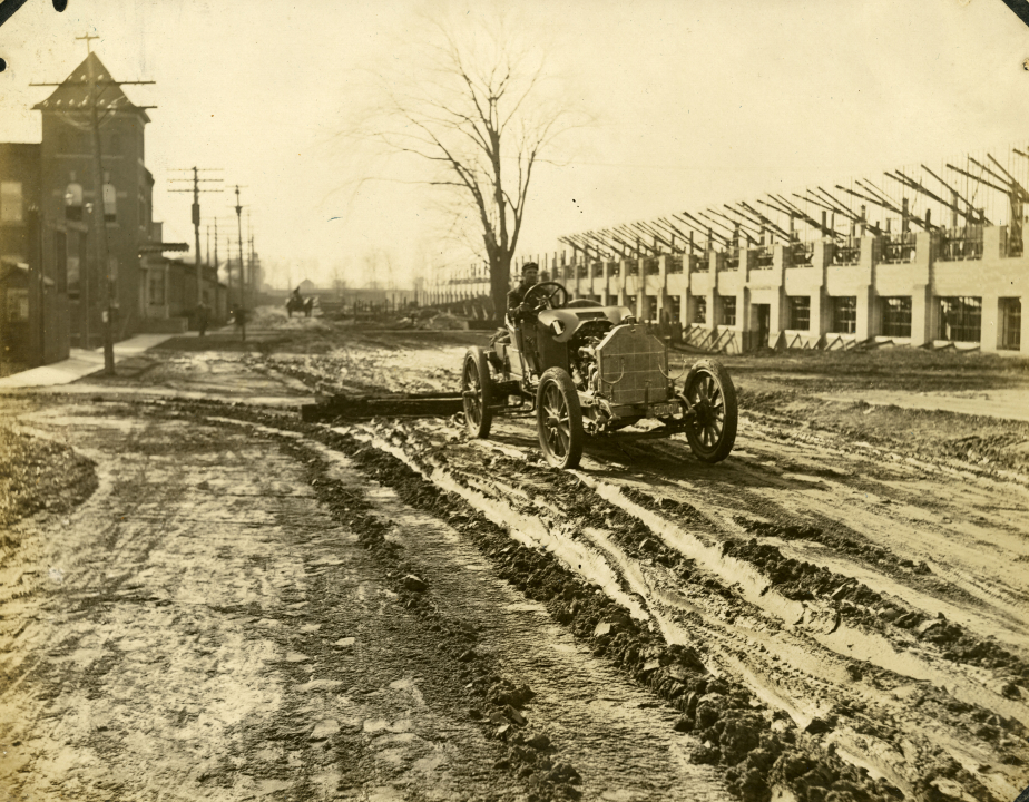 Photograph, Unidentified streetscape, car pulling King Drag, undated. (AC1332-0000005)