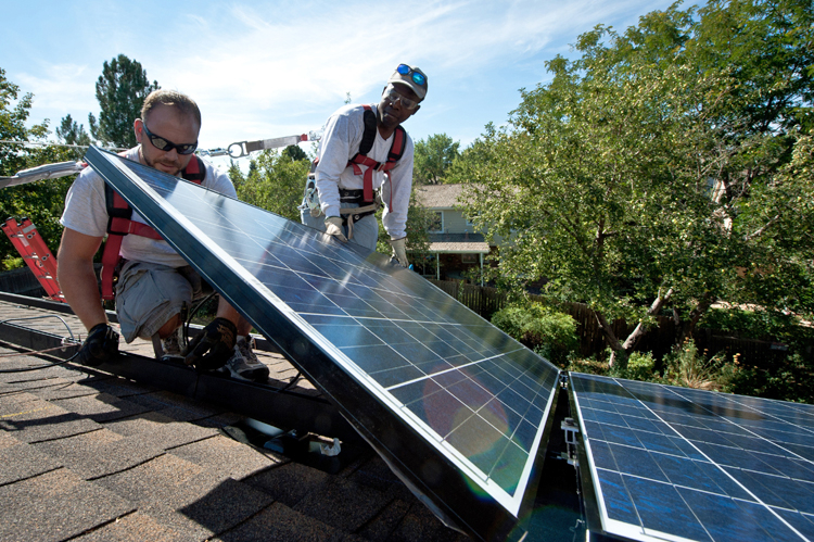 Workers installing solar panels on a home in Englewood, Colorado, 2012