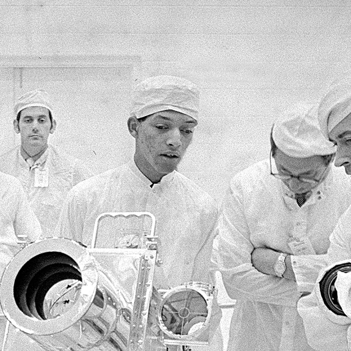 Inventor George Carruthers in a clean room with others in lab gear