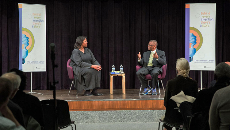 Lisa Cook and Lonnie Johnson talking on stage