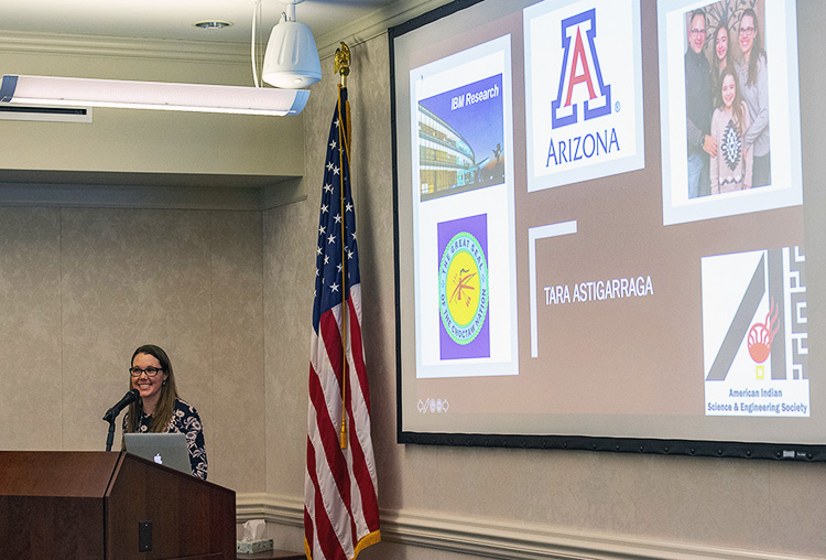 Astigarraga speaking at a podium with slide on the screen