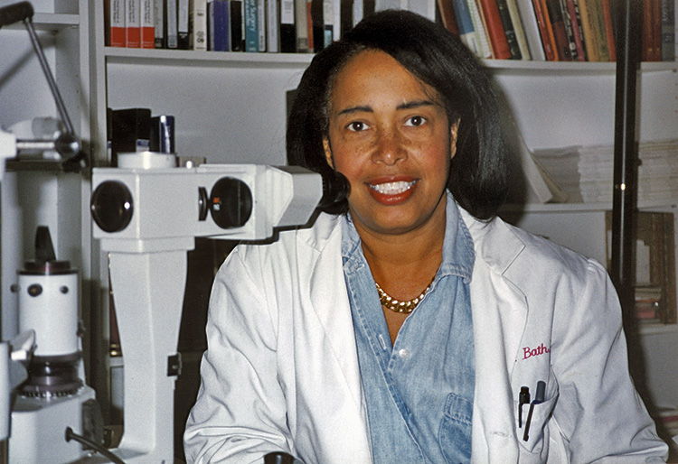 Dr. Bath in lab coat with microscope