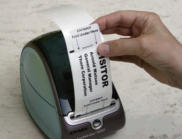 A small thermal printer producing a time badge.