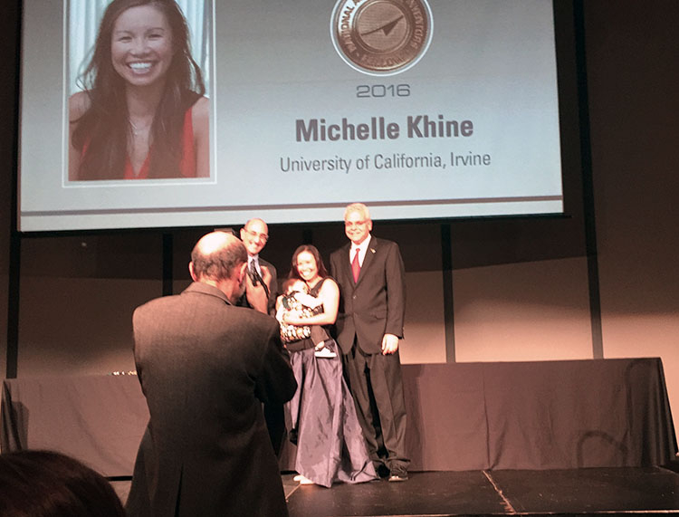 Khine receiving award