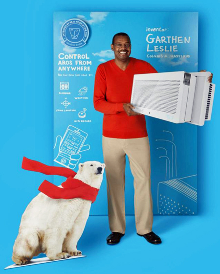 Advertising image showing inventor Garthen Leslie holding the Aros air conditioner that he invented. He stands against a backdrop of blueprint-type sketches for the air conditioner. A cut-out of a polar bear wearing a red scarf is at his feet.