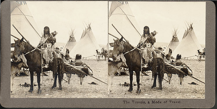 Historic photo of Native Americans with traditional travois sled