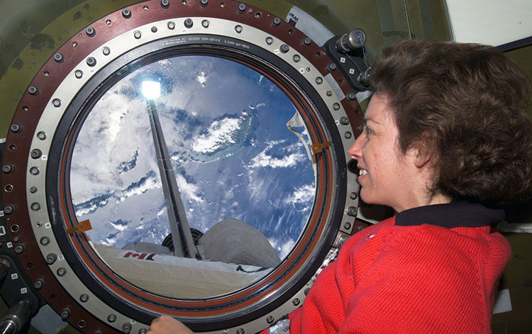 Ochoa looking out space station window