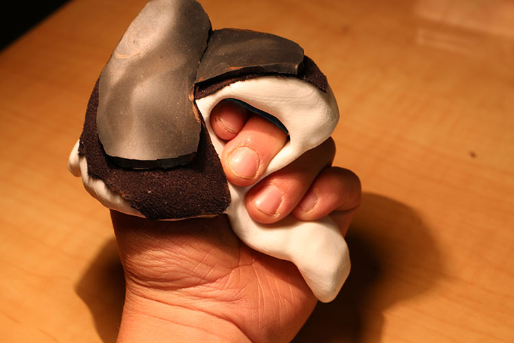 Close-up of a hand inside a hard racing glove