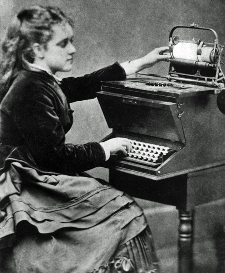 Lillian Sholes seated at a Remington Model 1 typewriter, about 1874