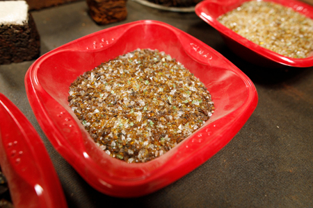 A small red bowl filled with pellets of crushed glass